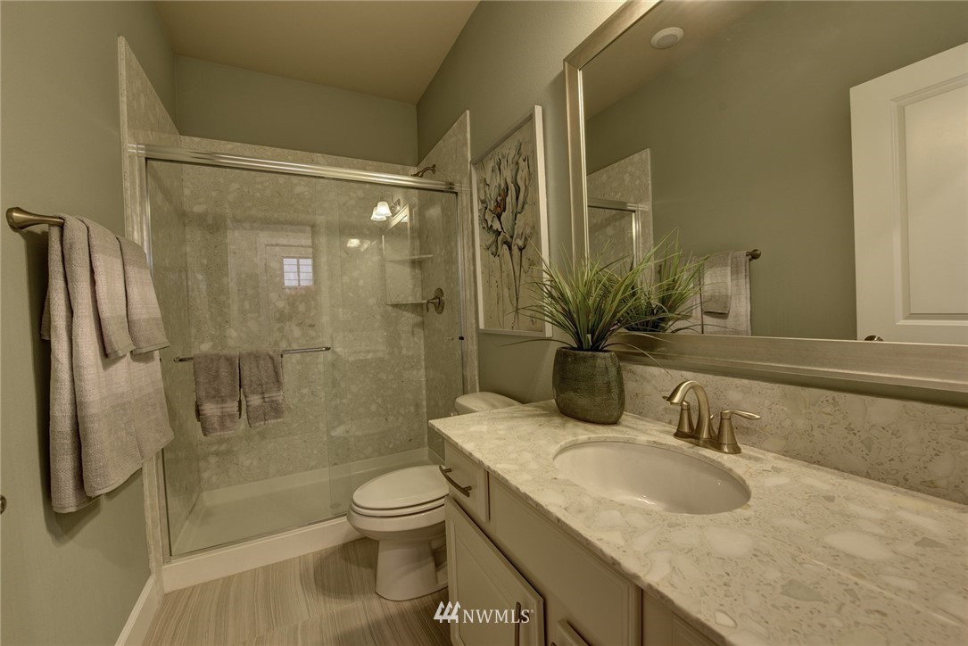 4130 174th Street Southeast Bothell, WA 98012 - Photo 12 of 29 a bathroom with a granite countertop sink toilet and shower