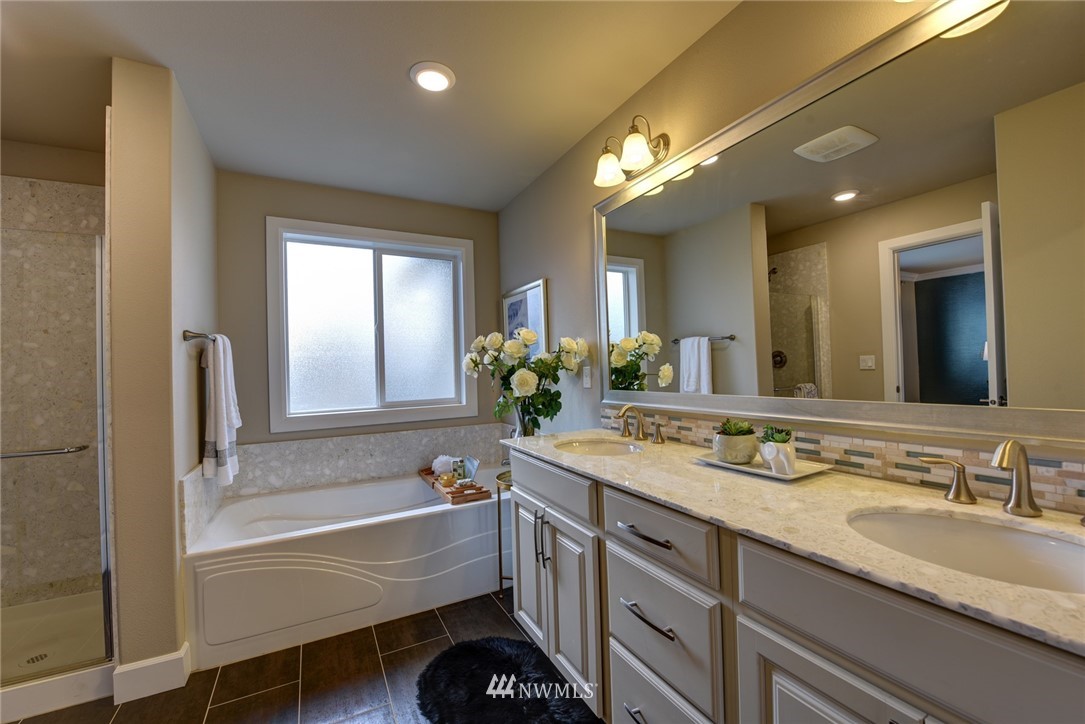 4130 174th Street Southeast Bothell, WA 98012 - Photo 16 of 29 a bathroom with a granite countertop sink mirror and a bathtub