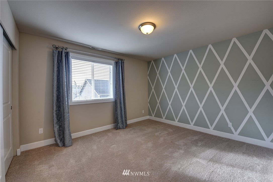 4130 174th Street Southeast Bothell, WA 98012 - Photo 23 of 29 an empty room with wooden floor and windows