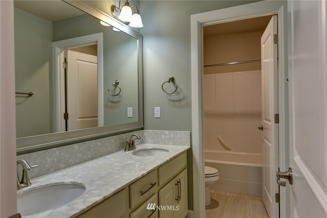 4130 174th Street Southeast Bothell, WA 98012 - Photo 24 of 29 a bathroom with a granite countertop sink and a mirror