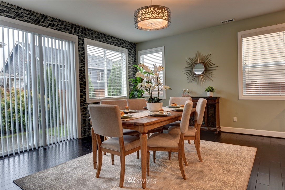 4130 174th Street Southeast Bothell, WA 98012 - Photo 4 of 29 a view of a dining room with furniture and wooden floor