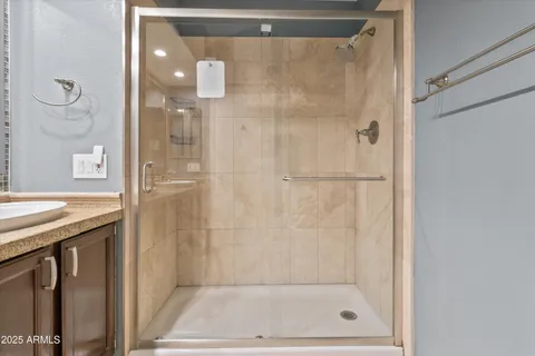 a bathroom with a granite countertop sink a toilet and bathtub