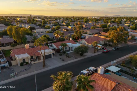 an aerial view of a houses with swimming pool