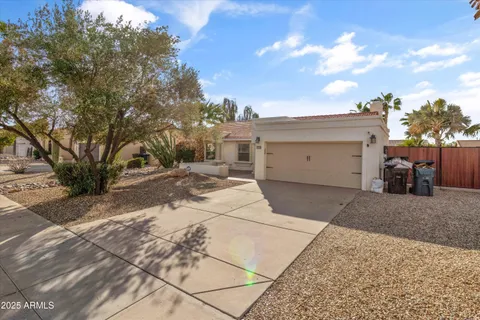 a view of a white house with a yard and garage