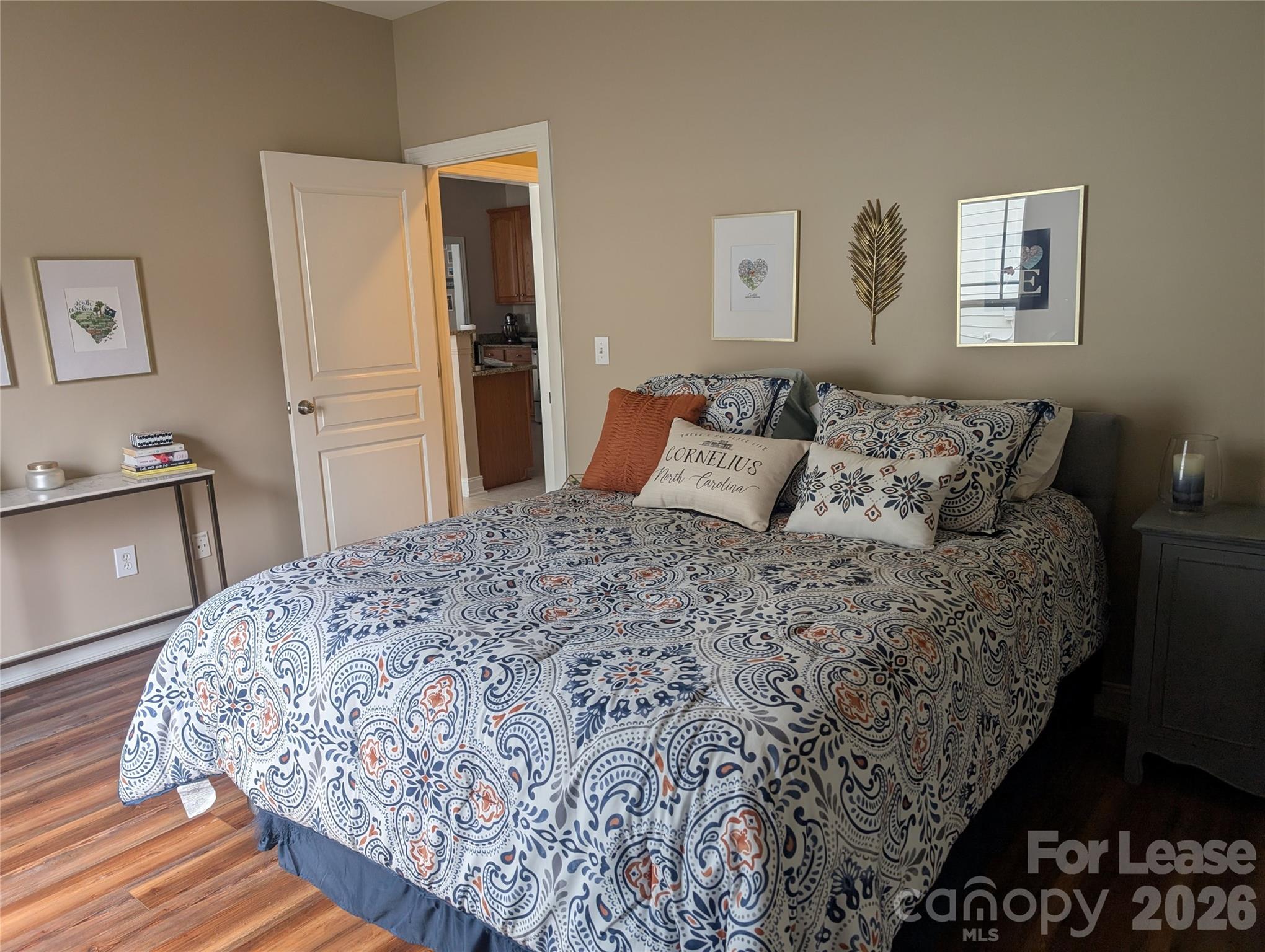 20207 Colony Point Lane Cornelius, NC 28031 - Photo 19 of 26 a bedroom with a bed and wooden floor