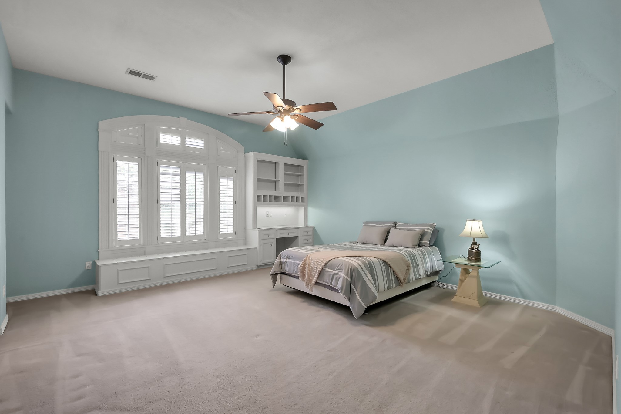 16403 Agusta Court Spring, TX 77379 - Photo 19 of 36 a spacious bedroom with a bed chandelier painting on the wall and a large window