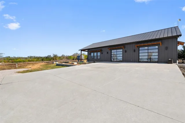 an empty room with fan and windows