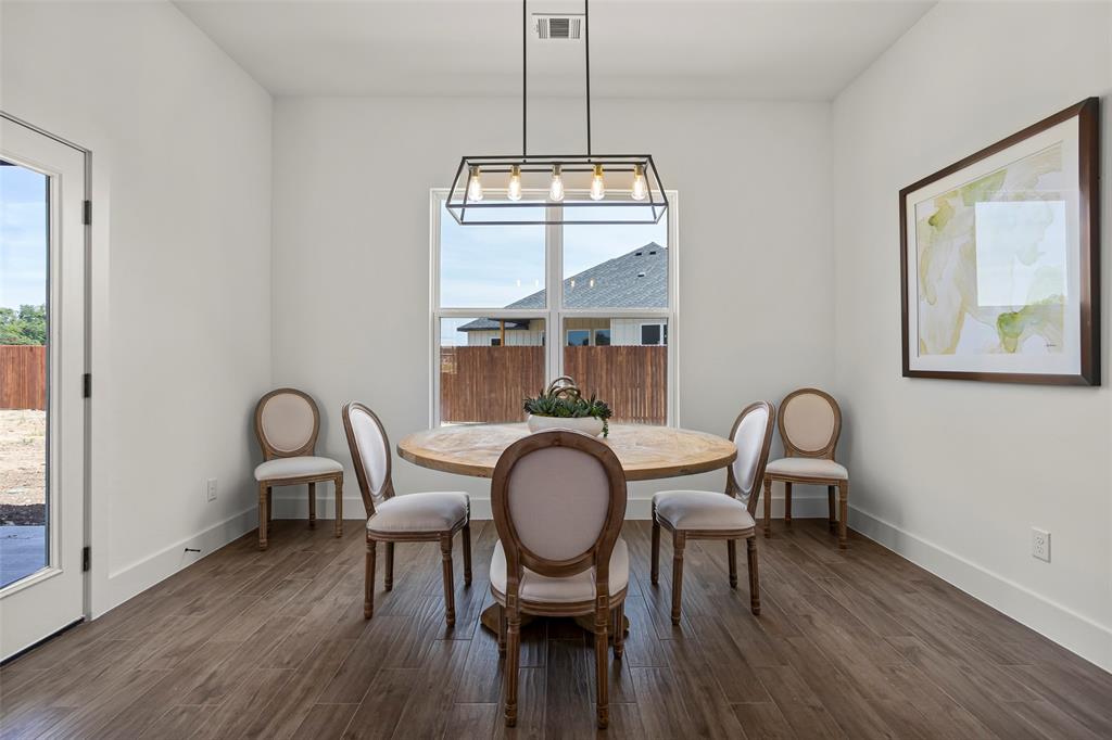204 Cliff Court Godley, TX 76044 - Photo 13 of 27 a dining room with furniture a chandelier and wooden floor