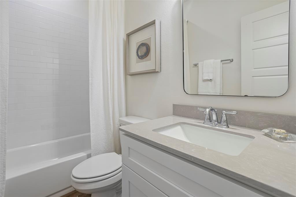 204 Cliff Court Godley, TX 76044 - Photo 19 of 27 a bathroom with a granite countertop toilet sink and mirror