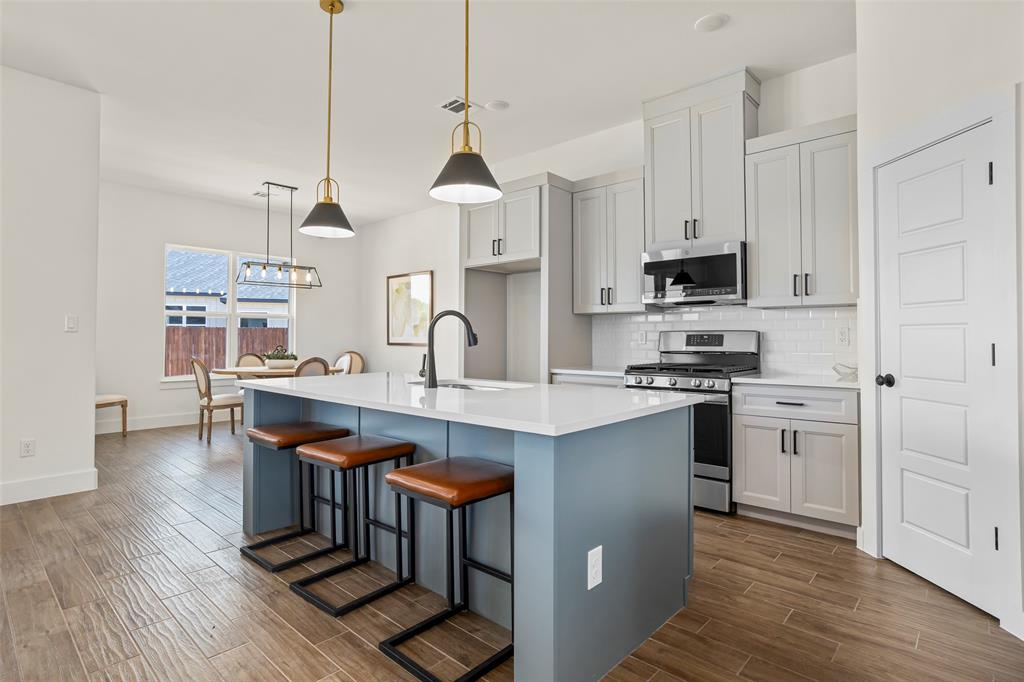 204 Cliff Court Godley, TX 76044 - Photo 10 of 27 a kitchen with stainless steel appliances a sink a stove a refrigerator and cabinets