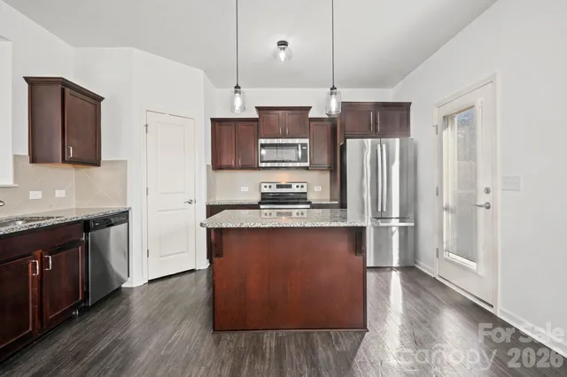 a kitchen with granite countertop cabinets and steel stainless steel appliances