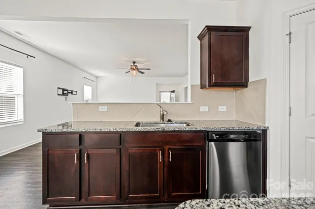 a bedroom with a bed a couch and a flat screen tv