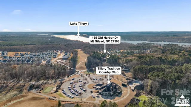 a view of a hallway with wooden floor and a bathroom