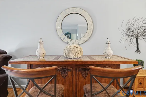 a dining room with furniture and a mirror