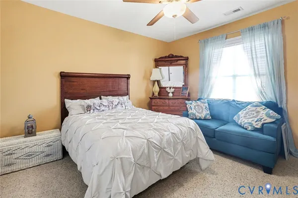 a bedroom with a bed and a mirror