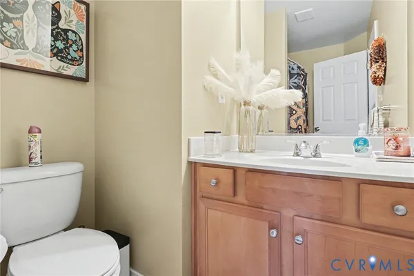 a bedroom with two beds and painting on the wall
