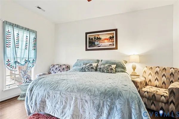 a bedroom with two beds and painting on the wall