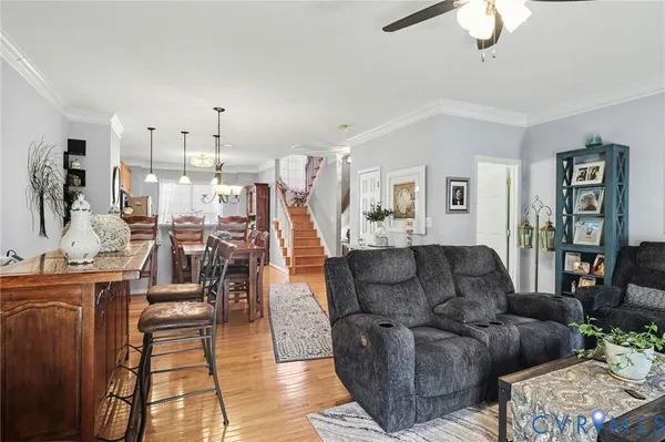 a living room with furniture and a chandelier