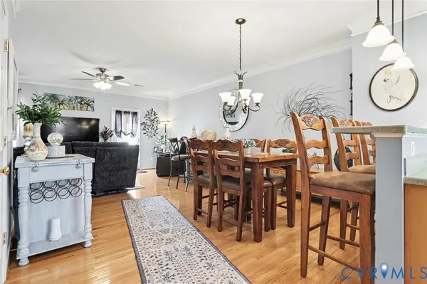 a living room with dining table and chairs