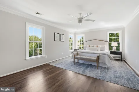 a room with walk in closet and wooden floor