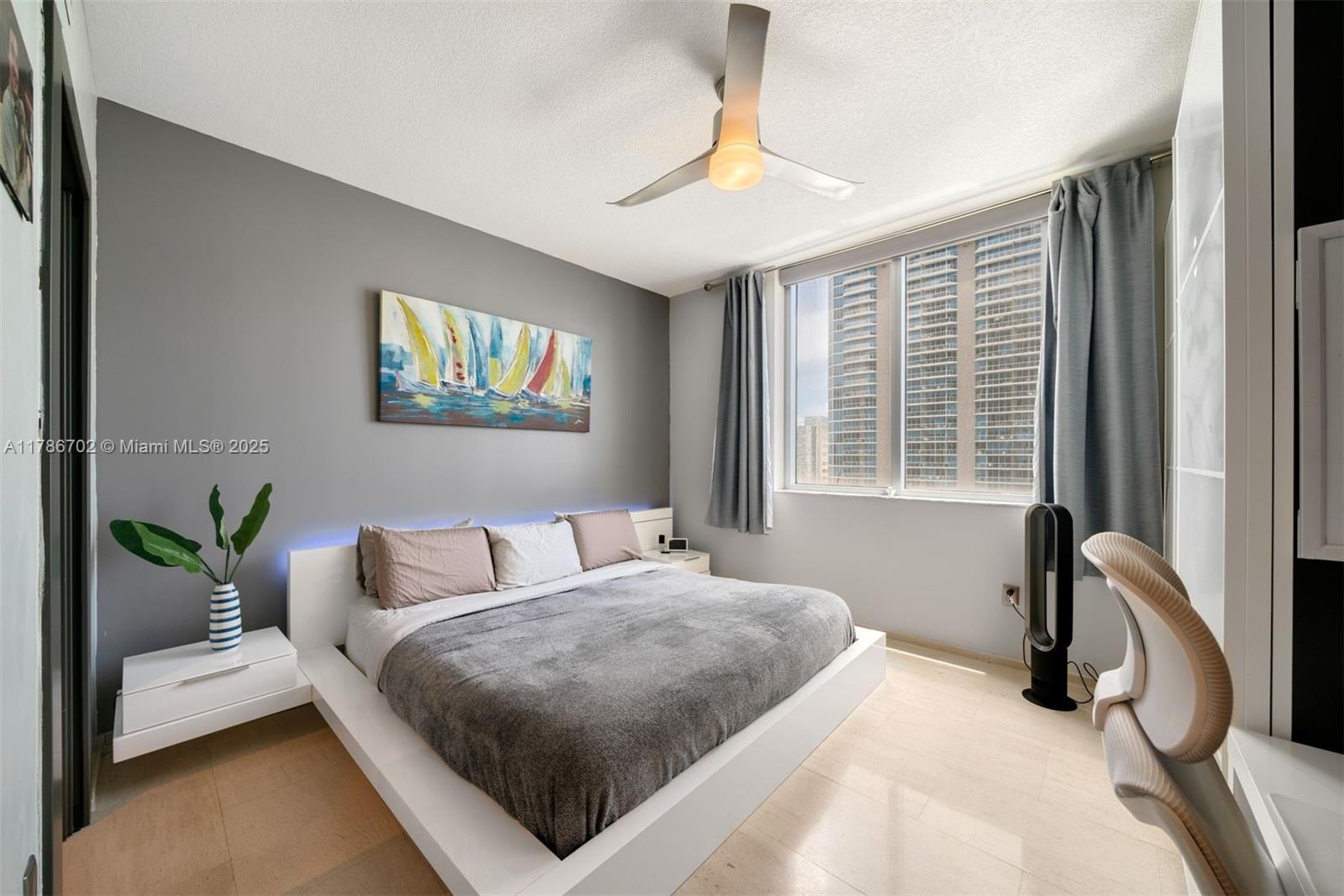 1060 Brickell Avenue, Unit 3003 Miami, FL 33131 - Photo 12 of 39 a bedroom with a bed and a couch