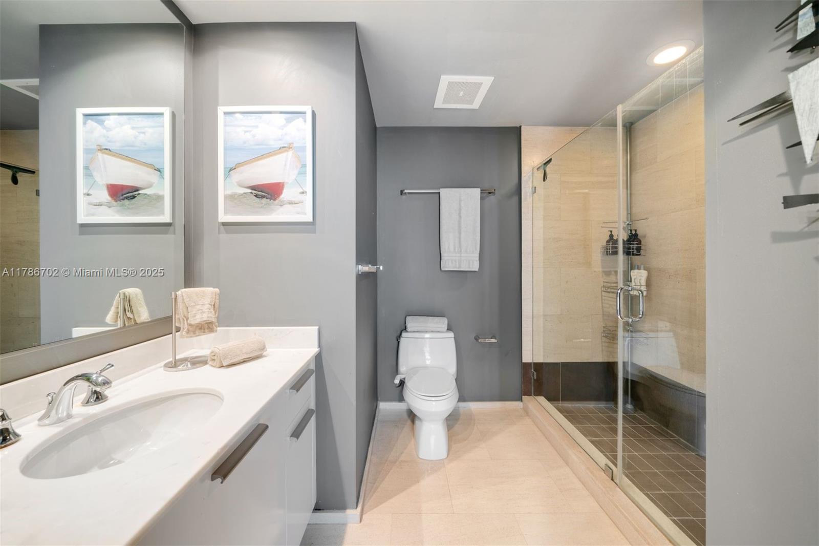 1060 Brickell Avenue, Unit 3003 Miami, FL 33131 - Photo 15 of 39 a bathroom with a sink and mirror with toilet