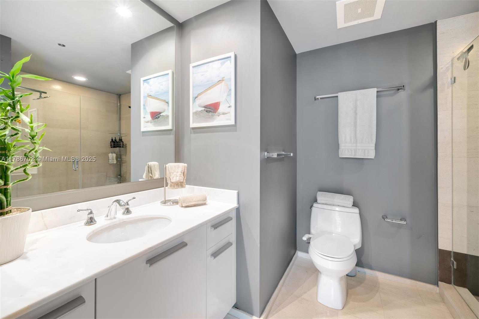 1060 Brickell Avenue, Unit 3003 Miami, FL 33131 - Photo 16 of 39 a bathroom with a sink toilet and a mirror