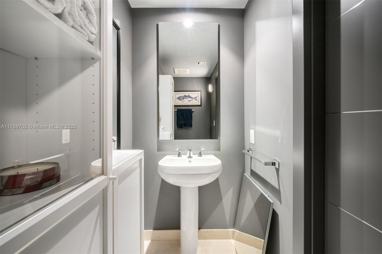 1060 Brickell Avenue, Unit 3003 Miami, FL 33131 - Photo 17 of 39 a bathroom with a sink a toilet and a mirror