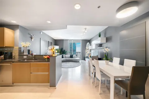 a kitchen with stainless steel appliances kitchen island granite countertop a sink and cabinets