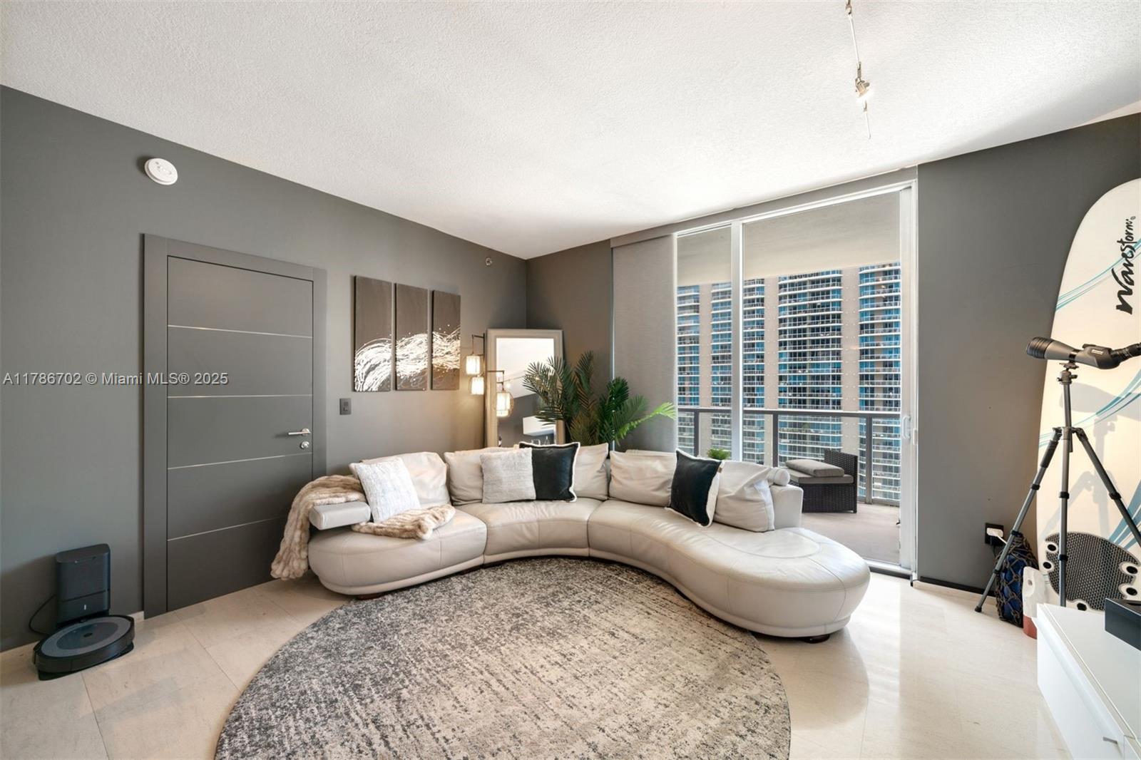 1060 Brickell Avenue, Unit 3003 Miami, FL 33131 - Photo 3 of 39 a living room with furniture and a large window