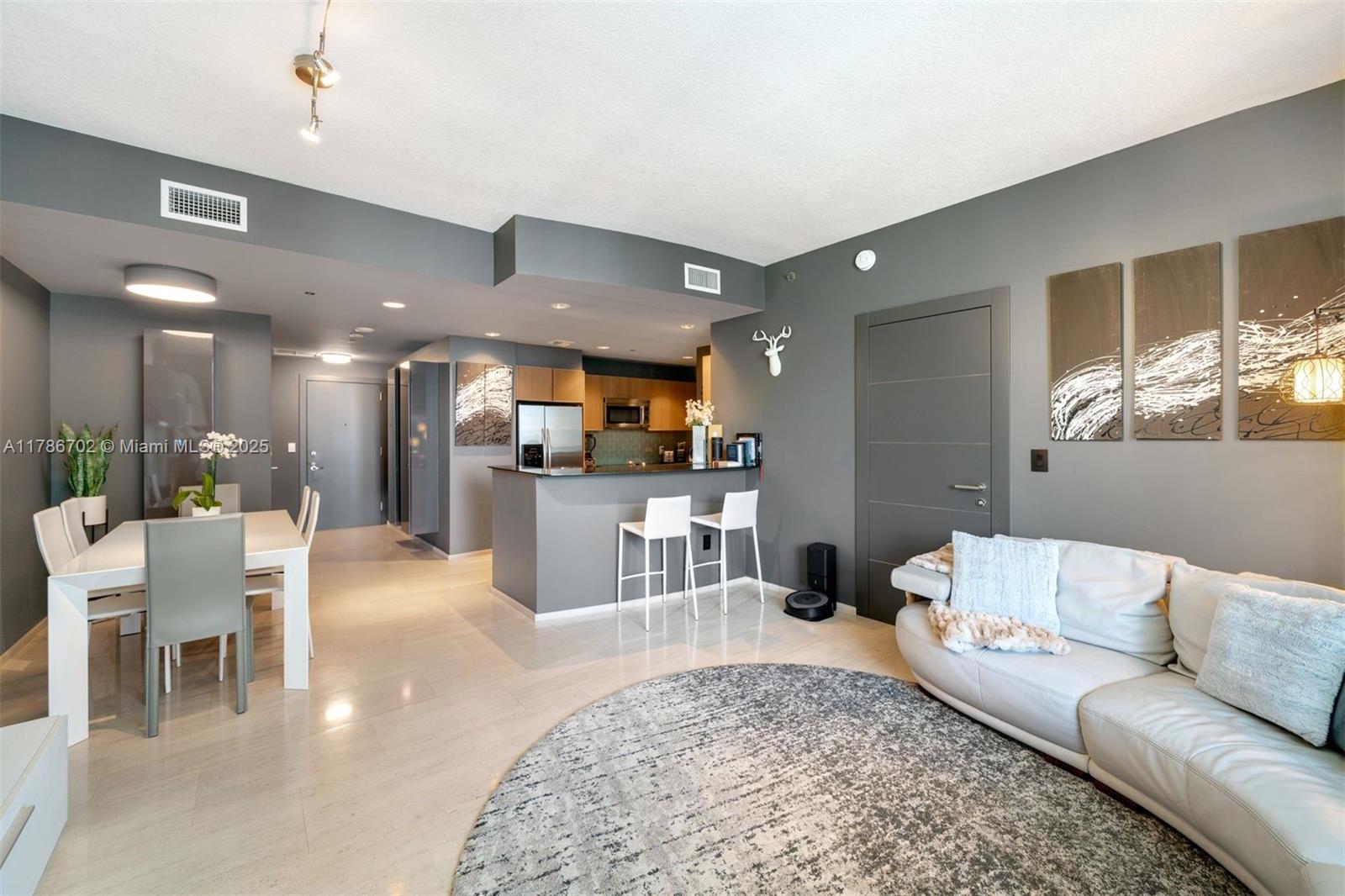 1060 Brickell Avenue, Unit 3003 Miami, FL 33131 - Photo 4 of 39 a living room with furniture and kitchen view