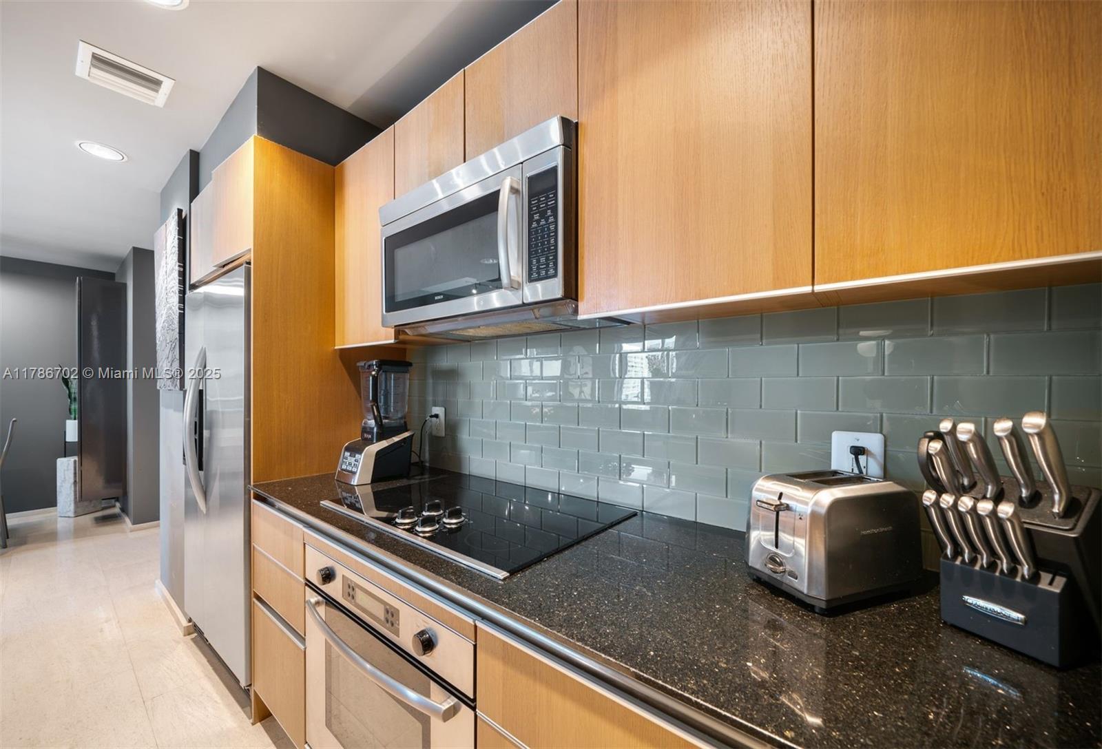 1060 Brickell Avenue, Unit 3003 Miami, FL 33131 - Photo 8 of 39 a kitchen with a sink and cabinets