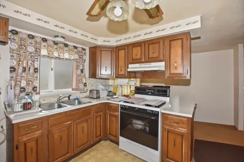 a kitchen with a sink stove and cabinets