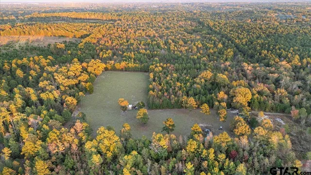 an aerial view of lake and residential houses with outdoor space