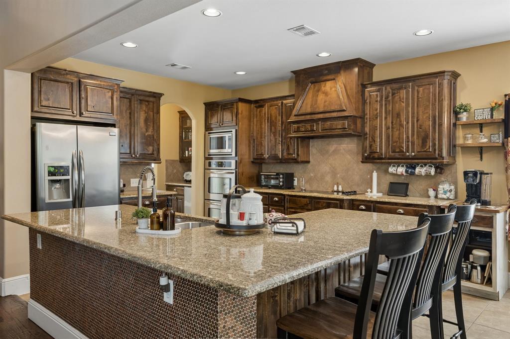 8104 Red Riv Run North Richland Hills, TX 76180 - Photo 10 of 38 a kitchen with stainless steel appliances granite countertop a sink refrigerator and cabinets