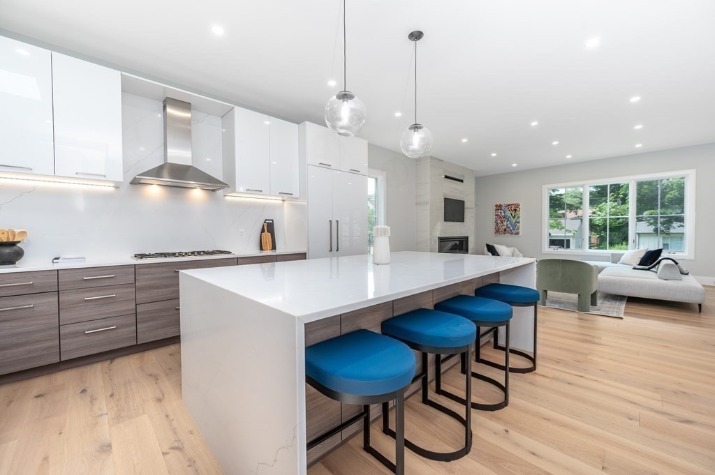 142 Bellingham Road Chestnut Hill, MA 02467 - Photo 9 of 37 a kitchen with granite countertop white cabinets stainless steel appliances and dining table
