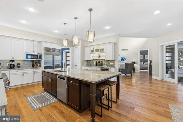 a living room with fireplace furniture and a large window