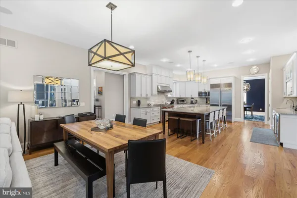 a bedroom with a large bed couch and a large window