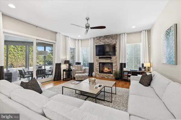 a bedroom with a bed a couch and a large window