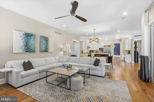 a bathroom with a double vanity sink a toilet a mirror and shower