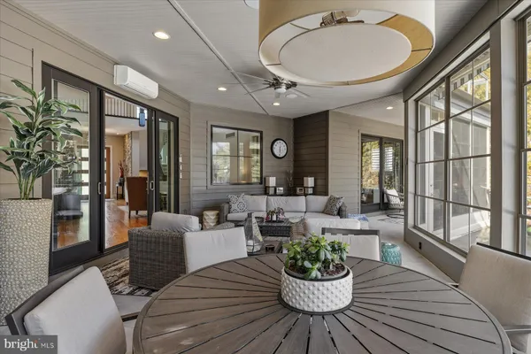 a living room with furniture a rug and a table
