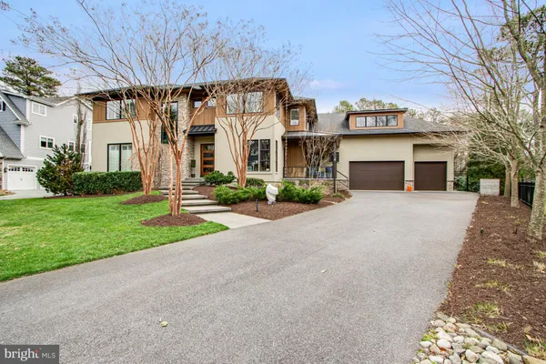 a kitchen with stainless steel appliances granite countertop a sink a stove and cabinets