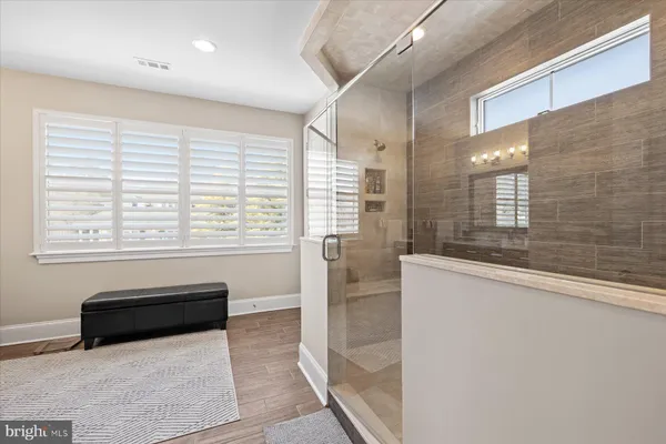 a bathroom with a toilet sink vanity and shower