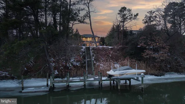 a living room with furniture kitchen view and a chandelier