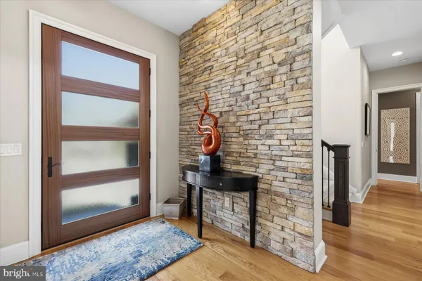 a dining room with furniture a chandelier and wooden floor