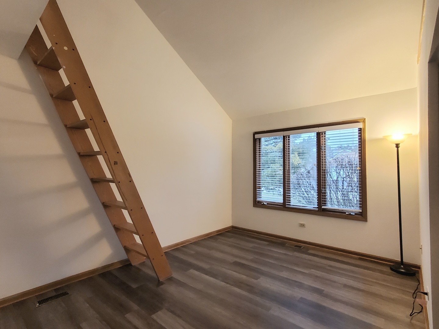 19212 Weber Road Mokena, IL 60448 - Photo 12 of 24 a view of an empty room with wooden floor and stairs