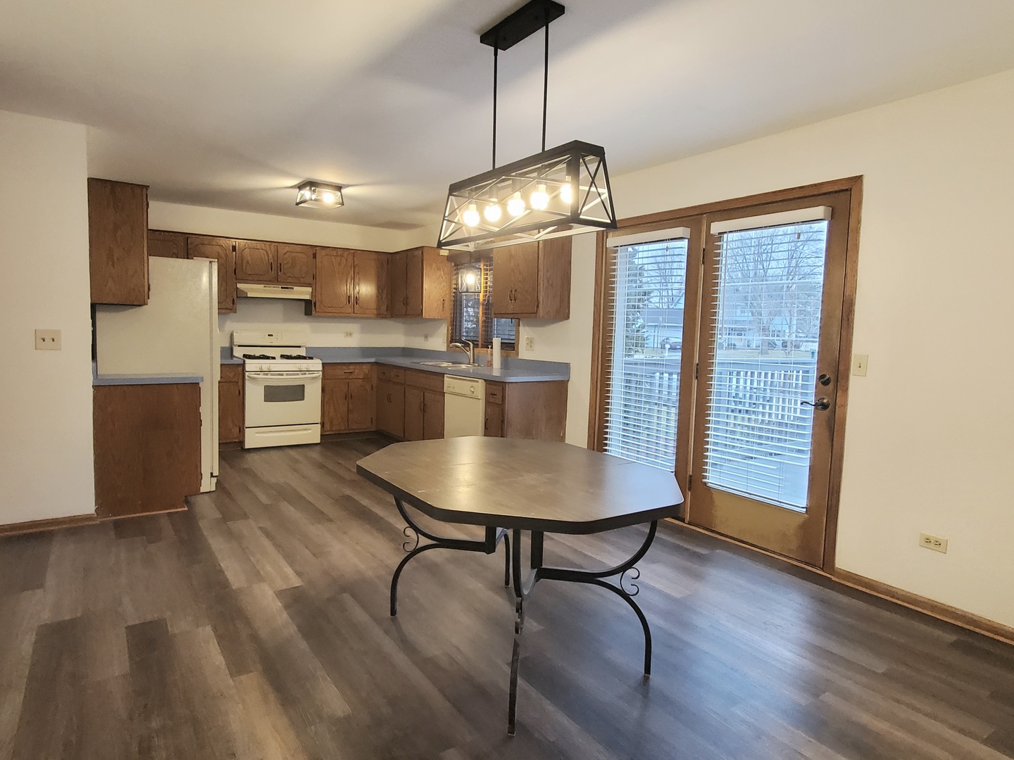19212 Weber Road Mokena, IL 60448 - Photo 3 of 24 a view of a dining room with furniture a chandelier and wooden floor