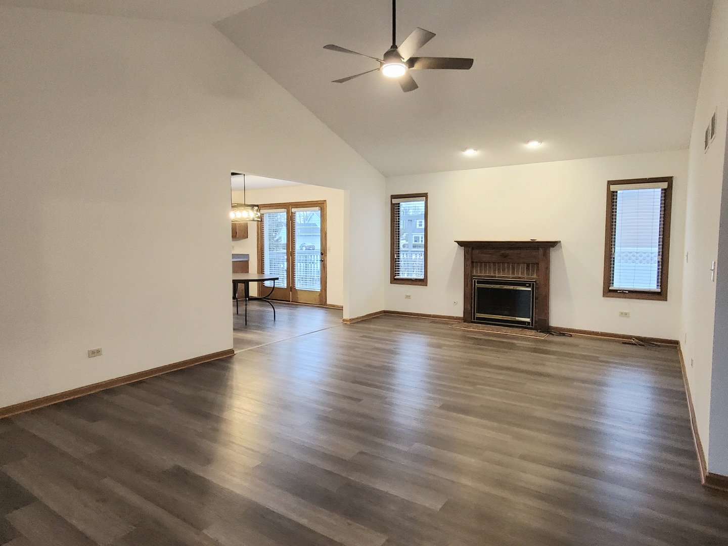 19212 Weber Road Mokena, IL 60448 - Photo 5 of 24 an empty room with wooden floor fireplace and a window