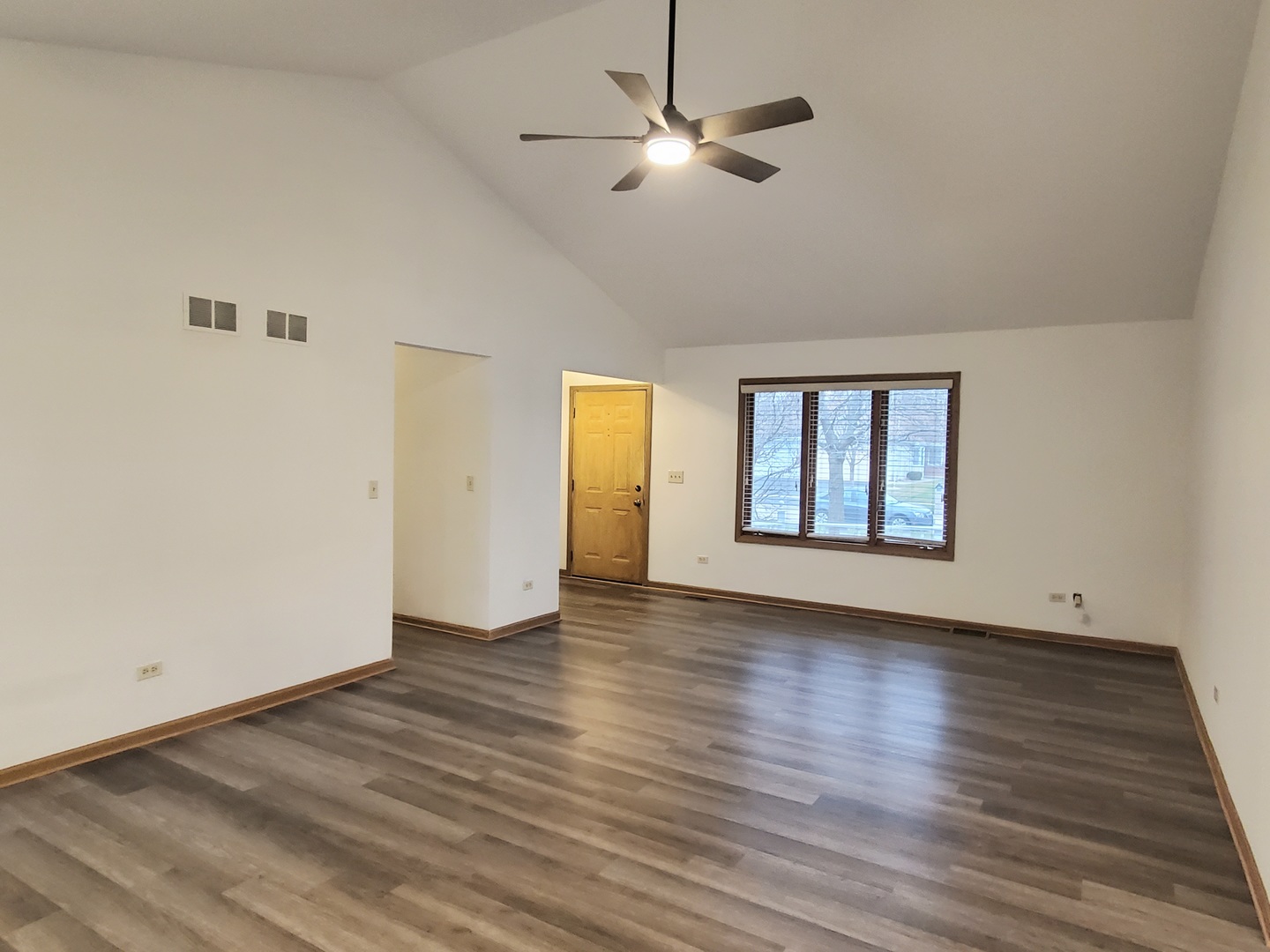 19212 Weber Road Mokena, IL 60448 - Photo 7 of 24 a view of an empty room with window and wooden floor