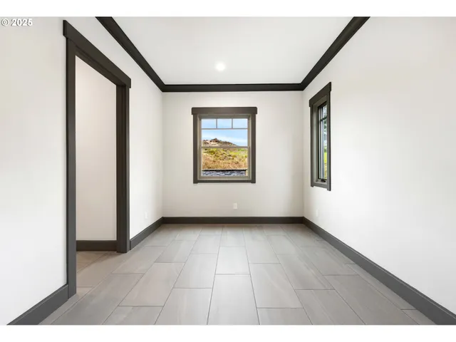 an empty room with windows and closet